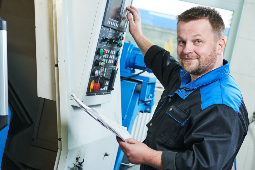 An industrial worker operating a machine